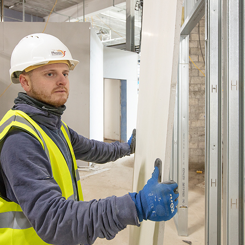 Man measuring board partitioning