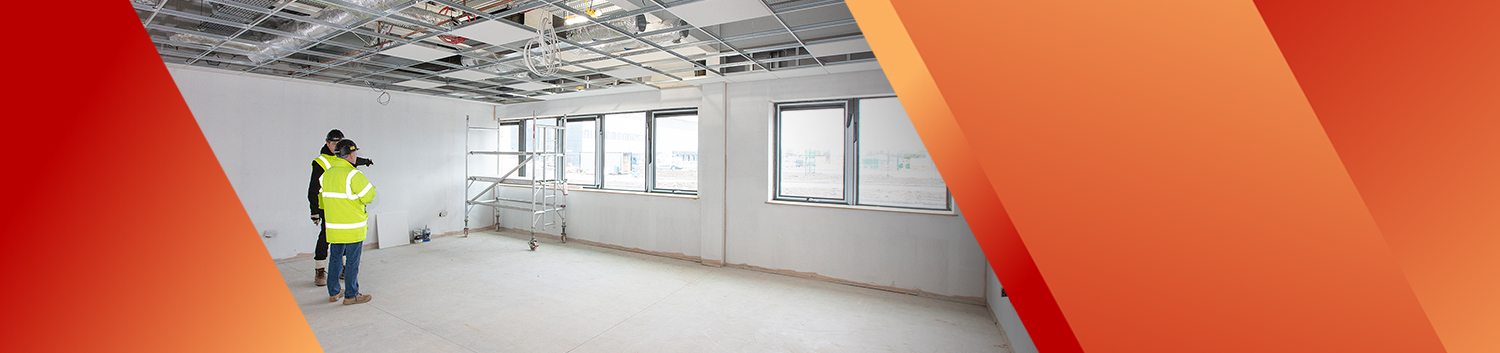 Men in commercial room with suspended ceiling